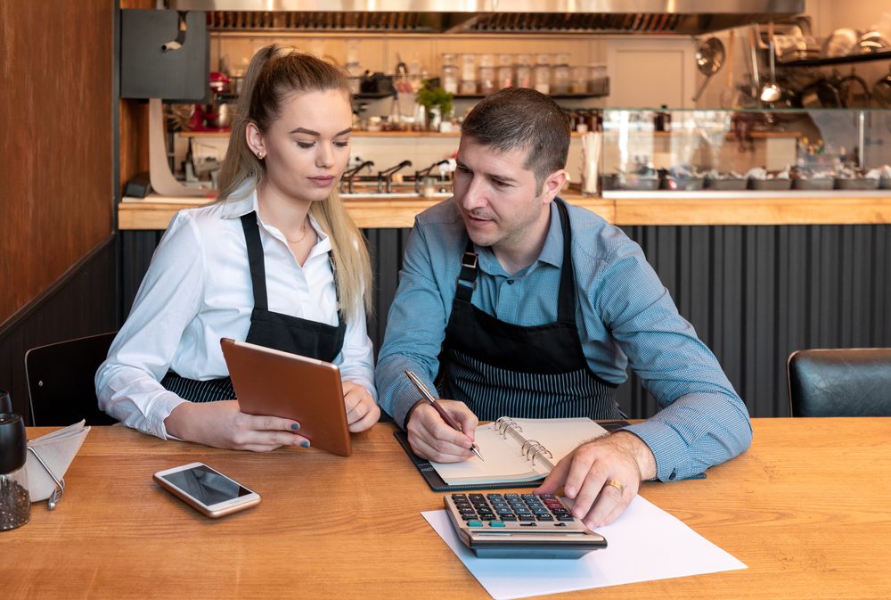 Two business owners going over their books together