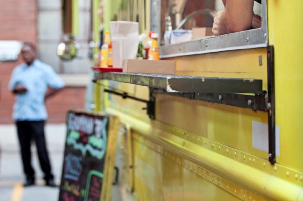 Food truck owner serving customers — a business handling POS and multi-state sales tax